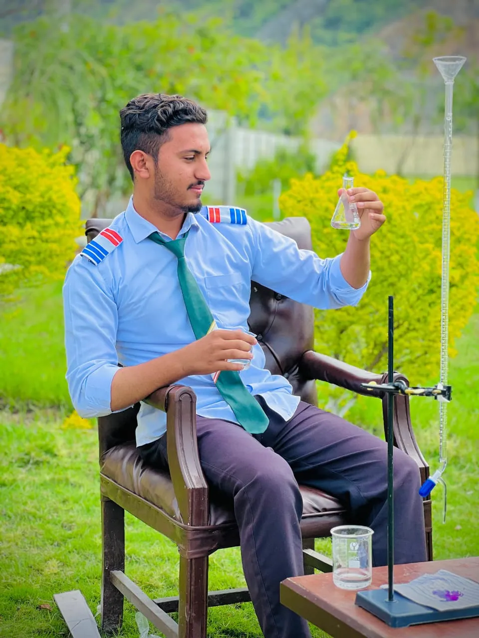 A teacher helping students with a physics experiment.
